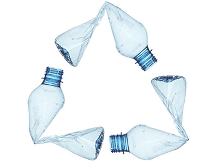A recycling symbol made from bend plastic water bottles.